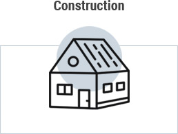 Grey circle clipart image of residential building with word construction above and rectangle around